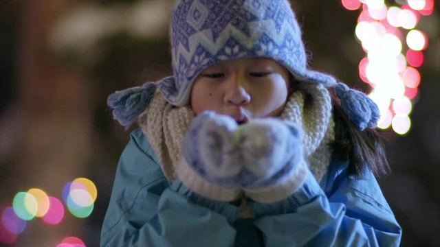 Cute Little Girl Blows Handful Of Snow At Camera (Slow Motion)