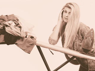 Woman holding iron about to do ironing