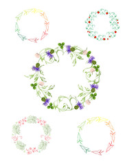 Obraz na płótnie Canvas Wreaths of herbal elements on a white background. Field flowers, cornflowers, clover and strawberries.