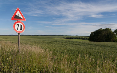 Road sign and a field.