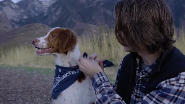 Outdoorsman Ties A Bandana Around His Dog's Neck