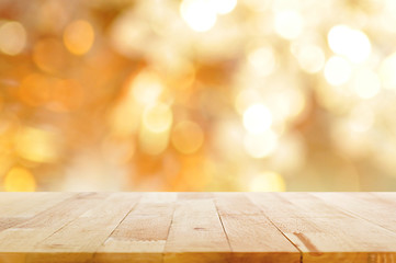 Wood table top on golden bokeh background