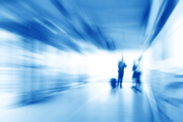 Blue business abstract background with people standing in the corridor, zoom effect