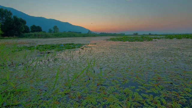 Morning sunrise time lapse above a lake, motorized slider HDR from RAW