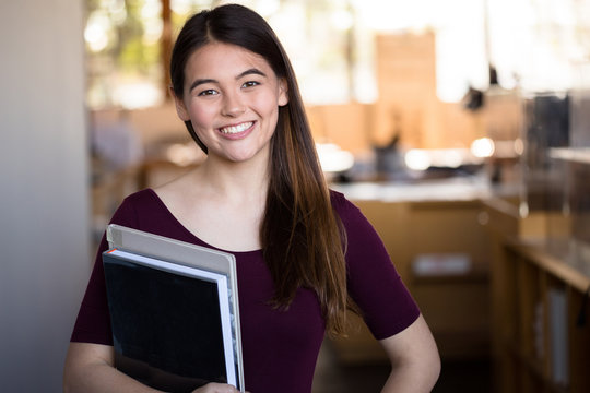 Happy University College Student Enthusiastic On Campus Walking To Class With Books And A Smile