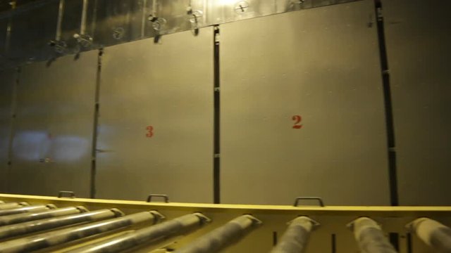 Closeup Modern Automatic Conveyor with Rollers at Bright Light