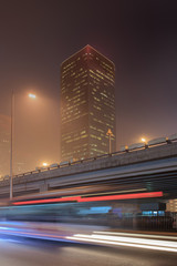 Urban nightime scenery with spyscrapers and traffic in motion blur, Beijing, China