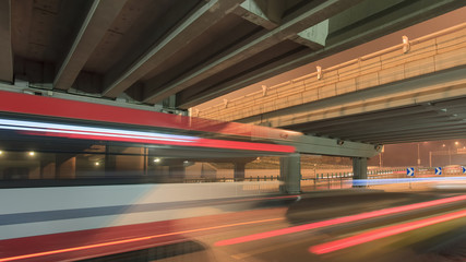 Fototapeta na wymiar Traffic in motion blur at underpass at night in Beijing, China