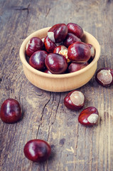 Fresh chestnuts on the old wooden table