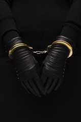 Golden handcuffs leather black gloves, concept