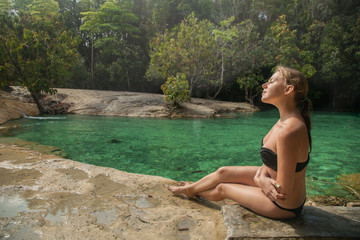 Fototapeta premium Girl walking on Emerald pool waters near Krabi, Thailand, Asia