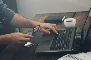 Businessman working with laptop at home office