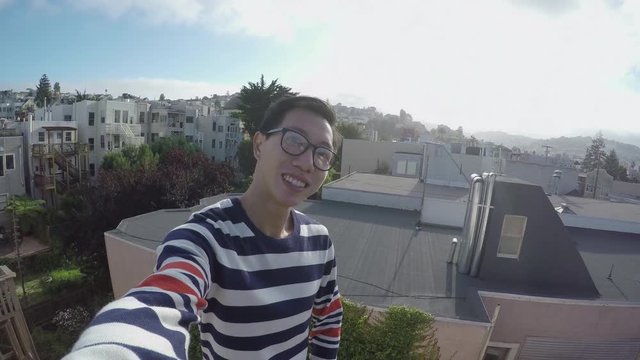 Chinese Man Takes A Selfie On A Rooftop With Beautiful San Francisco Neighborhood In the Background 