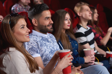 Young cheerful people smiling joyfully relaxing at the movie theatre watching comedy film friends friendship entertainment activity leisure fun positivity lifestyle.