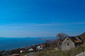 Fototapeta premium Stone village house whit the panoramic view on the blue sky and sea
