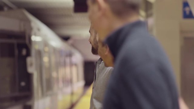 Two Gay Couples Chat While They Wait For Their Subway Train To Pull Up To Platform 