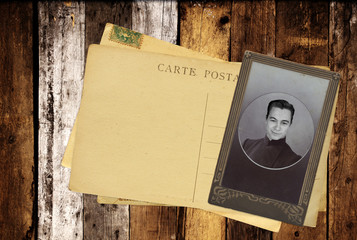 Vintage post cards and retro photo on old wooden planks