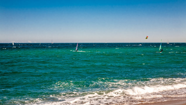 Wind surfers on the blue sea