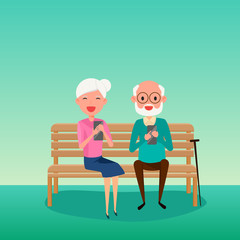 Elderly couple.Happy Grandparents day. Grandparents using smart phone sitting on a bench in the park.