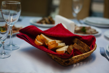 Bread in basket with butter under sunlight