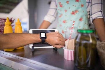 Fototapeta na wymiar Man paying bill through smartwatch