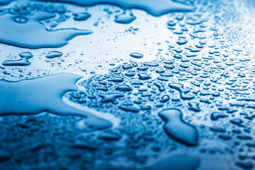 Wet metal background,in blue tone.