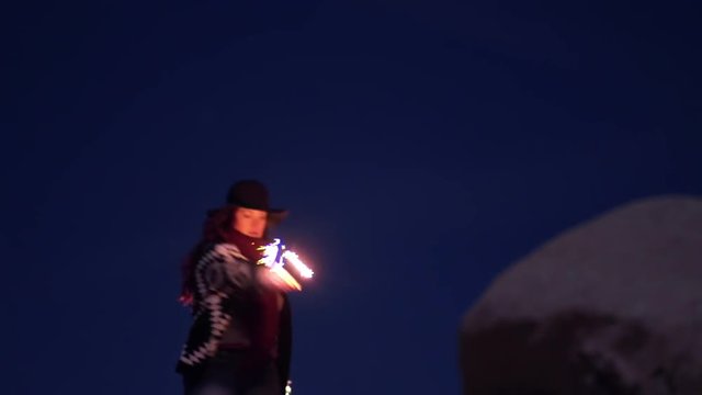 Woman Dances In The Desert With Sparklers