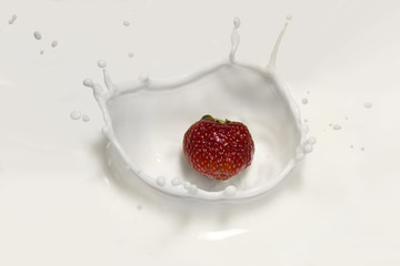 A splash of milk. A falling red strawberry. Dessert.