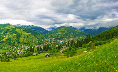 Fototapeta na wymiar Village located on the slope of a mountain ridge, nature background, panorama