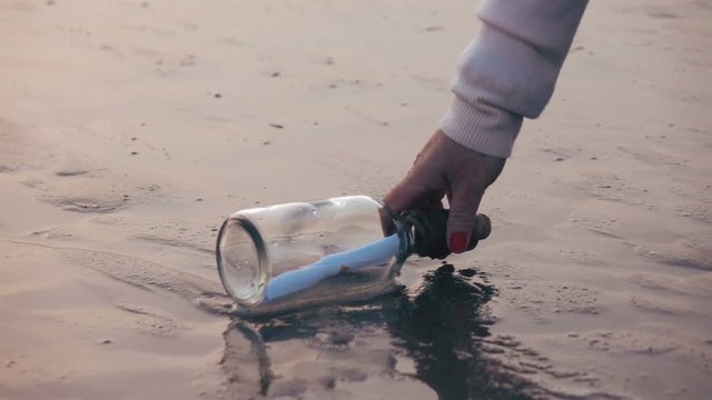 High quality video of picking up message in the bottle in real 1080p slow motion 250fps. More videos from this series in my portfolio