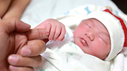 the love of mother and hand of new born.