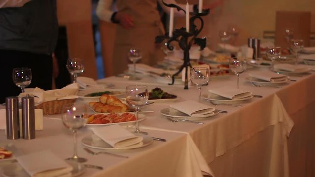 Waitress put dishes at the table