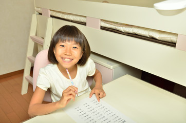 Naklejka premium 子供部屋で勉強する小学生の女の子