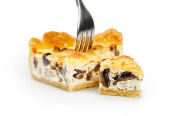 Slice of chicken & mushroom pie on the fork isolated on white. Focus on little piece of pie 