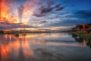  Landscape of sunset  bridge crossing Ping river at Tak ,Thailand
