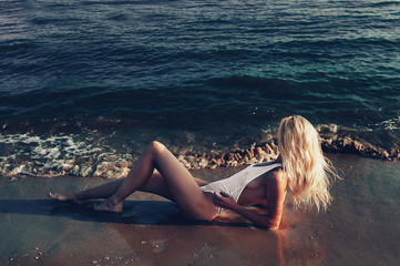 Slim and athletic girl in a swimsuit on the beach