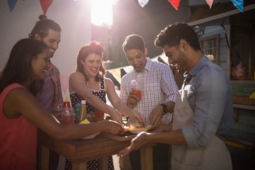 Waiter serving food to customers