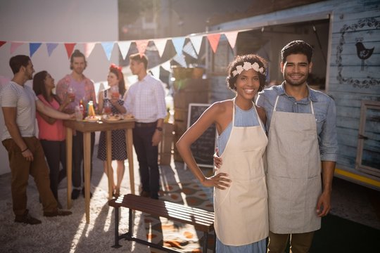 Portrait of happy waiter and waitress