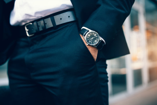 Business man's hand in pocket wearing a watch