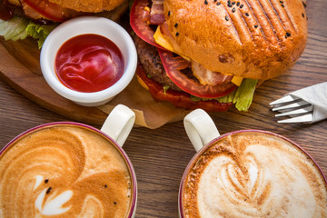 serving fast food and two cups of coffee and a fork on the table in the restaurant