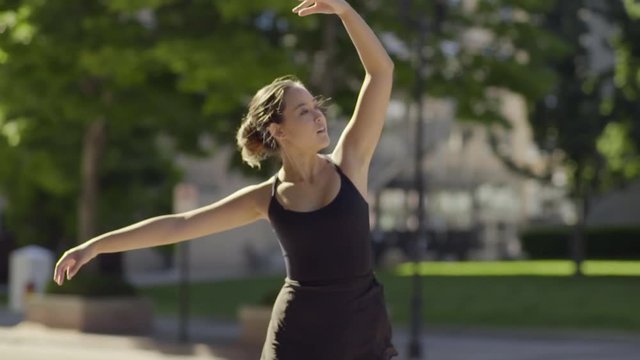 Elegant Ballerina Dances, En Pointe, In City Park (Slow Motion)