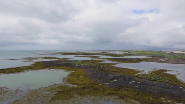 Stunning Drone footage over the beach, town and sea landscape of Stokkseyri in iceland.