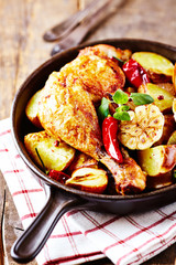 Spicy Chicken Leg with Baked Potatoes, Garlic and Chili Peppers