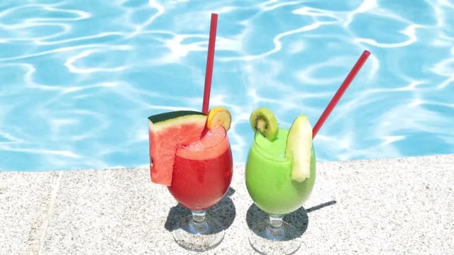 Cocktails on the background of the pool. Two fruit cocktails. Summer and rest.