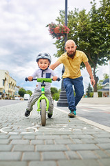 Father teaching his son to ride a bike