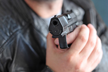 man with hand gun pistol rubber attack violence