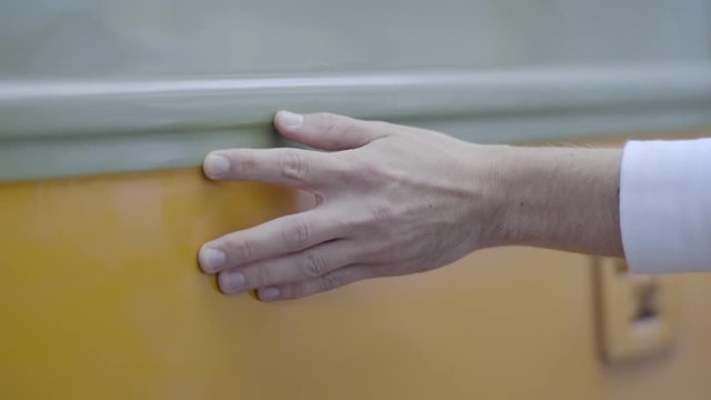 Man Walks Along Colorful Vintage Street Car And Touches The Side Of It (Slow Motion, Closeup Of His Hand)