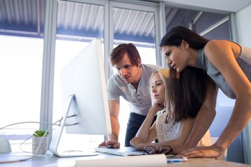Executives discussing over computer during a meeting