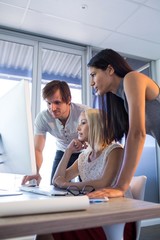 Executives discussing over computer during a meeting