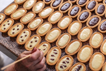 Woman hand decorating mini tarts